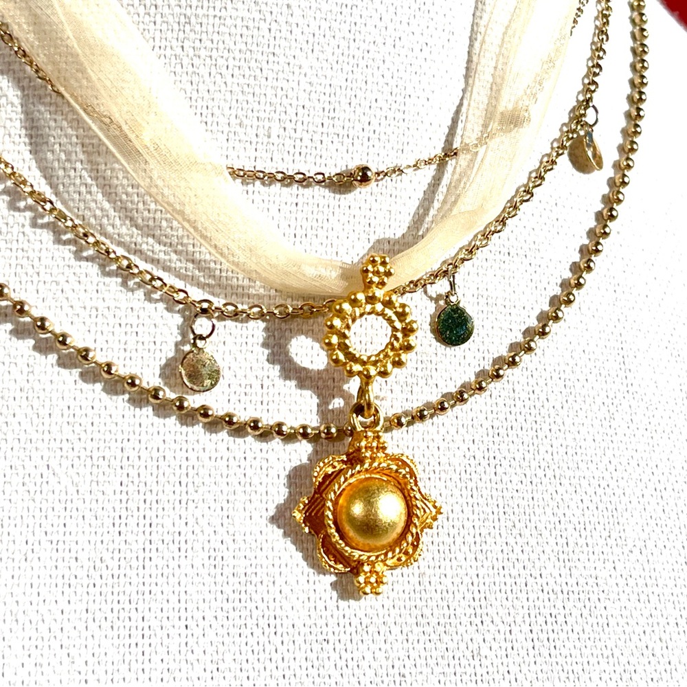 Sheer choker necklace with matte gold tone round pendant